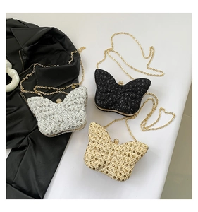 Close-up of glittery butterfly evening bags with metal ball clasp and gold chain straps