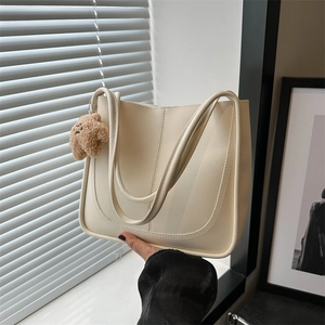 Minimalist cream white tote bag with long straps and brown teddy bear charm decor