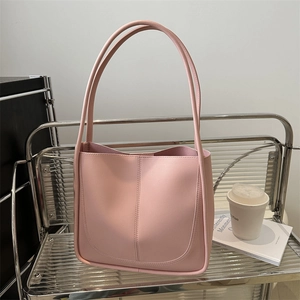 Pink faux leather large tote bag for women shown in a stylish lifestyle setting