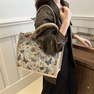 Vintage tote bag featuring colorful butterfly prints and botanical leaf patterns