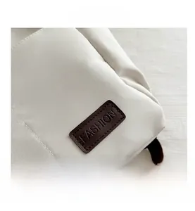 Detailed macro view of white canvas texture with embossed leather fashion patch
