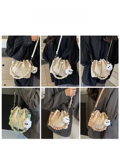 Detail showing woven bucket bags in cream and green with plush ball charms and straps