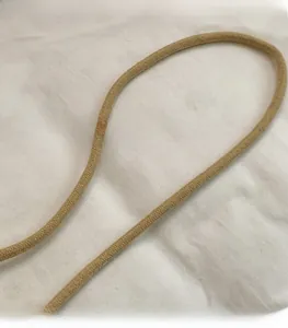 Detail of khaki woven cotton shoulder strap with fine braided texture on a casual bag
