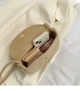 Top view of the interior space of this woven crossbody bag showing phone and wallet