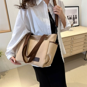 Minimalist beige canvas tote bag with brown straps and large capacity for daily use
