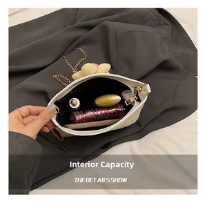 Vue intérieure montrant la capacité du sac en paille tressée beige à chaîne