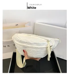 Detail of white chest bag showing ripple texture and braided rope zipper puller