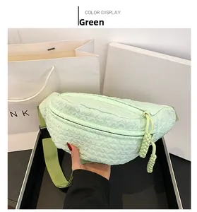 Detail view of mint green crossbody bag featuring unique bubble textured 3D fabric and strap