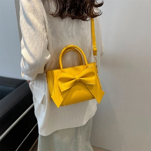 Stylish yellow bow handbag for women, elegant crossbody bag with top handle for spring 2024
