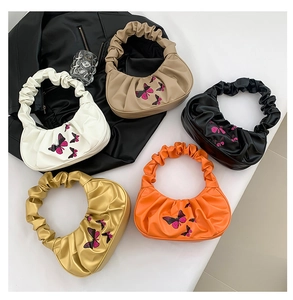 Detailed embroidery of purple butterflies on pleated cloud bags in five stylish colors