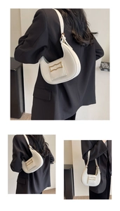 Detail shots of white leather hobo bag with a wavy gold buckle and shoulder strap design