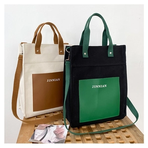 Close-up of contrast color canvas tote bags with adjustable straps and front pockets