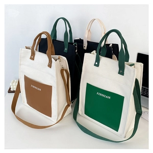 Detailed view of color-blocked canvas tote bags with PU front pockets in various colors