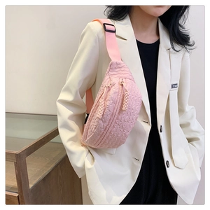 Detail of pink quilted texture on lightweight chest bag with dual zipper pullers