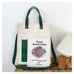 Detailed close-up of a minimalist canvas tote bag with green straps on a wooden table