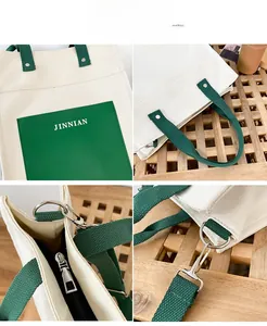 Detail view of large canvas tote bag showing green front pocket and sturdy metal hooks
