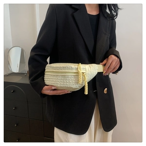 Adjustable crossbody bag in creamy yellow with textured bubble fabric on a model