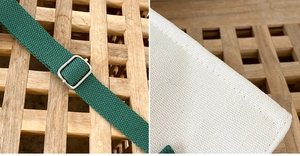 Detail of dark green woven strap with silver buckle and white canvas stitching