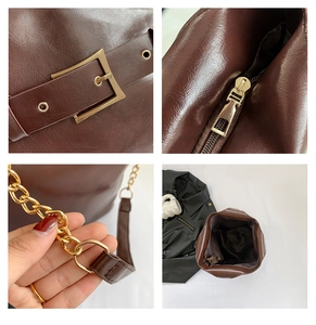 Gros plan sur la boucle en métal doré, le zip et la chaîne d'un sac cabas en cuir marron foncé