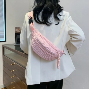 Minimalist pink bubble texture chest bag shown worn by a model over a beige blazer