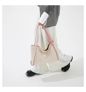 Detail of summer woven tote bag with pink faux leather straps and cream texture