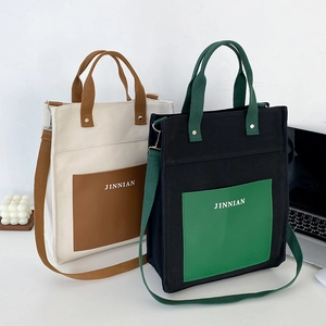 Minimalist large canvas tote bag for women with leather pocket and contrast shoulder strap