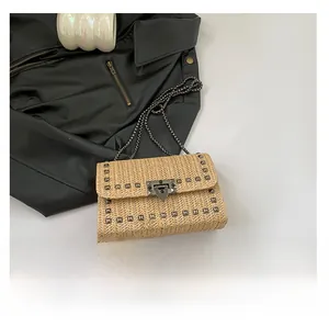 Vue détaillée du sac tissé kaki avec garniture de rivets argentés et bandoulière chaîne