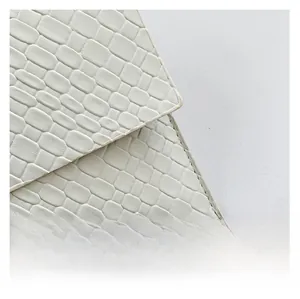 Close-up of premium white quilted fabric with geometric pattern and fine stitching details
