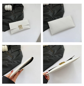 Detail of white envelope clutch featuring crocodile pattern and golden geometric hardware