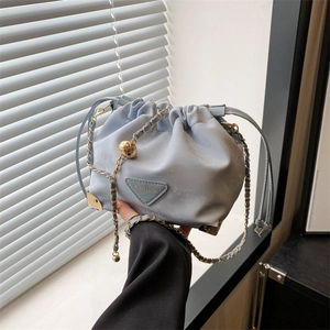 Chic light blue bucket bag with drawstring closure and golden chain strap for summer