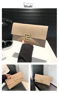 Detail of khaki quilted envelope clutch featuring a geometric gold metal buckle