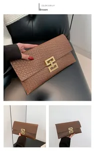 Close-up of brown textured envelope clutch featuring a gold H-shaped buckle detail