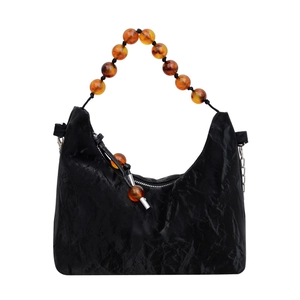 Fashionable black pleated cloud hobo bag with unique amber beaded handle and silver chain