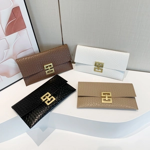 Quilted women's envelope clutches in black, white, and brown with gold geometric buckles