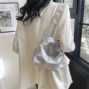 Silver metallic pleated handbag with adjustable shoulder strap and smooth PU leather finish