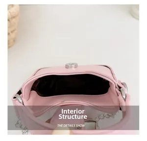 Internal view of pink bow purse showing brown lining and silver magnetic buckle
