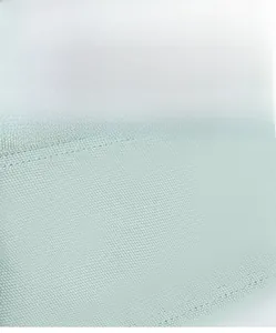 Close-up of mint green canvas fabric texture showing durable double-stitching details
