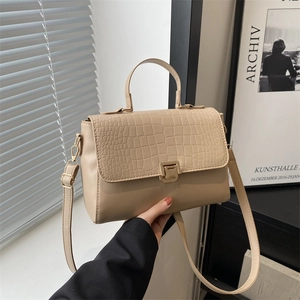 Minimalist beige crossbody handbag with crocodile texture flap and gold metal buckle