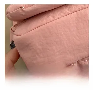 Detalle de las costuras precisas y la textura de la tela rosa del bolso pequeño