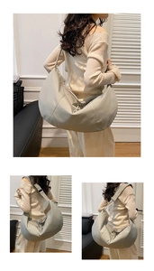 Detail view of large crescent hobo bag with tassel zipper and smooth matte leather