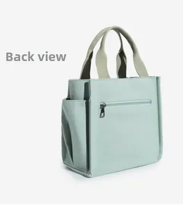 Back view of mint green canvas tote bag featuring a horizontal zipper pocket and side pockets
