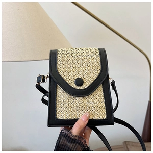 Close-up of the vintage woven crossbody bag with black leather trim and gold metal buckles