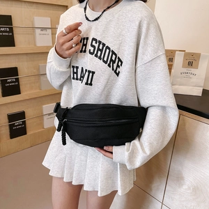 Detail view of black mesh fanny pack with breathable honeycomb fabric and woven zipper pull
