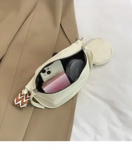 Detailed interior view of creamy white leather crossbody bag with spacious storage capacity