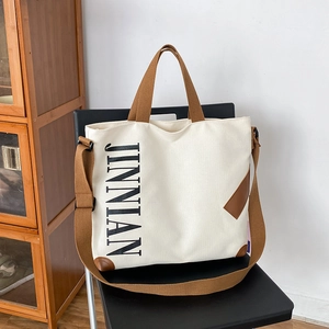 Sac cabas minimaliste en toile crème avec anses marron et imprimé texte stylé