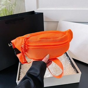Detail of bright orange mesh waist bag featuring breathable fabric and woven zipper pull
