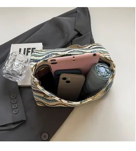 Spacious interior of the woven striped tote bag showing space for tablet and essentials