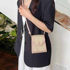 Women's woven straw mobile phone bag with dusty pink faux leather trim and strap