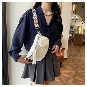 Close-up of a white lychee leather waist bag with a colorful geometric shoulder strap
