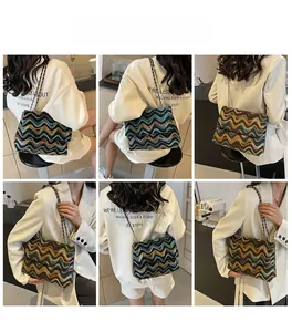 Multiple views of a wave-pattern crossbody bag with metal chain strap worn by a model